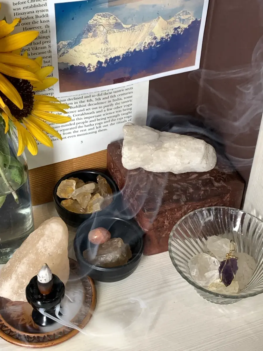 An altar with crystals for spiritual growth and image of Mt Nanda Devi