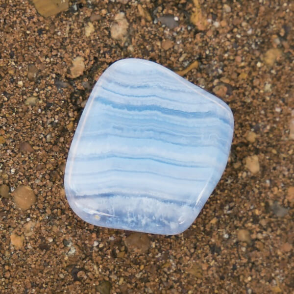 One Blue Lace Agate stone on a sandy beach