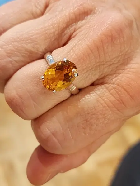 Citrine ring on the hand
