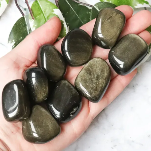 Nine pieces of Gold Sheen Obsidian Tumbled Stones on hand