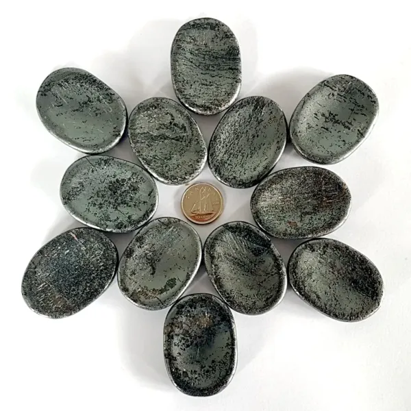 A group of Hematite Worry Stones in geometrical pattern with the coin in the middle