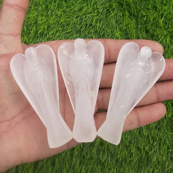 Three Milky Quartz Guardian Angels on palm of the hand.