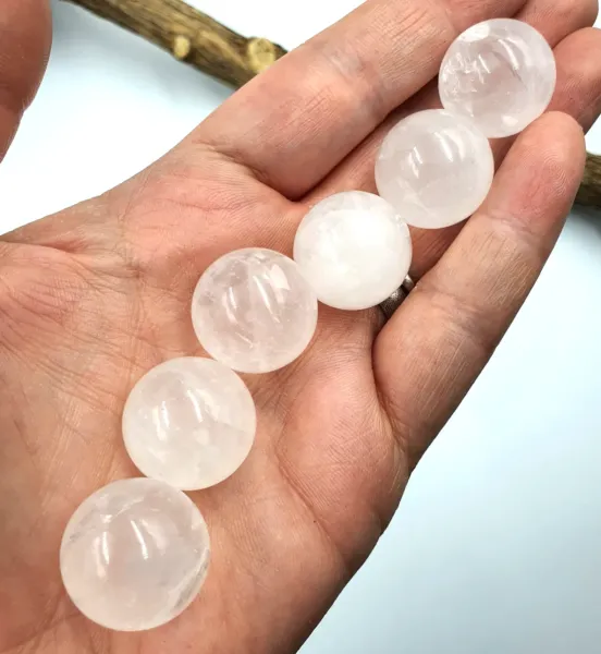 Six Milky Quartz Mini Spheres on palm.