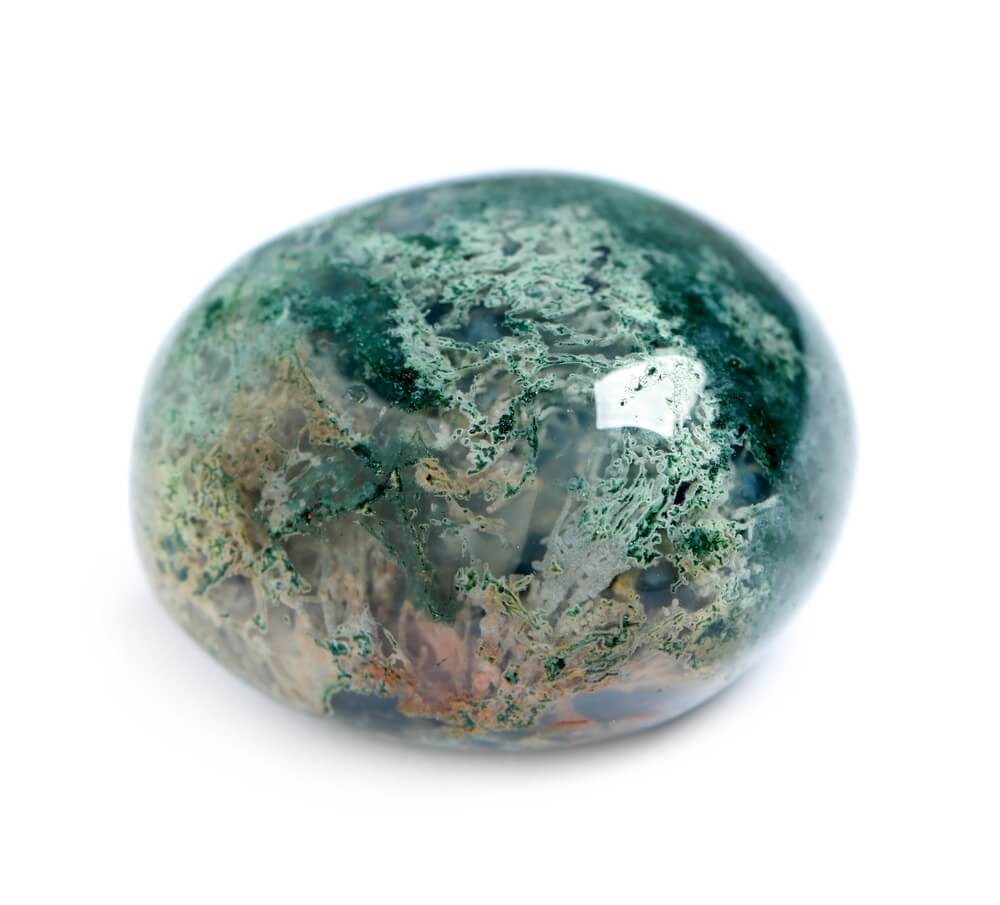 A round polished piece of Moss Agate