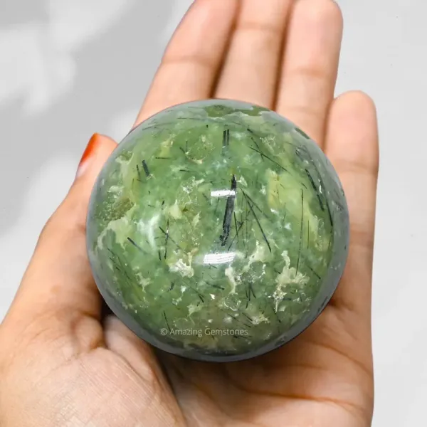 Natural Prehnite Sphere on palm of the hand
