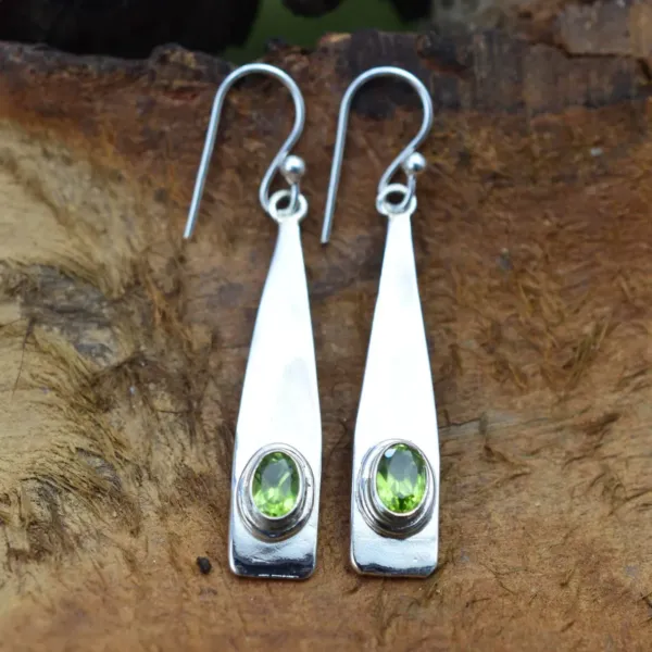 Peridot Hook silver Earrings on wooden background