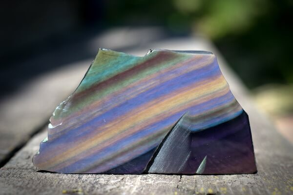 A polished piece of Rainbow Obsidian