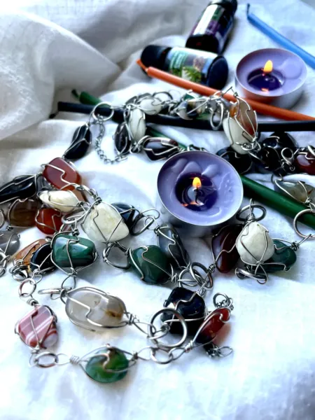 Tumbled aventurine, agate, carnelian, obsidian and quartz link together for healing with crystals