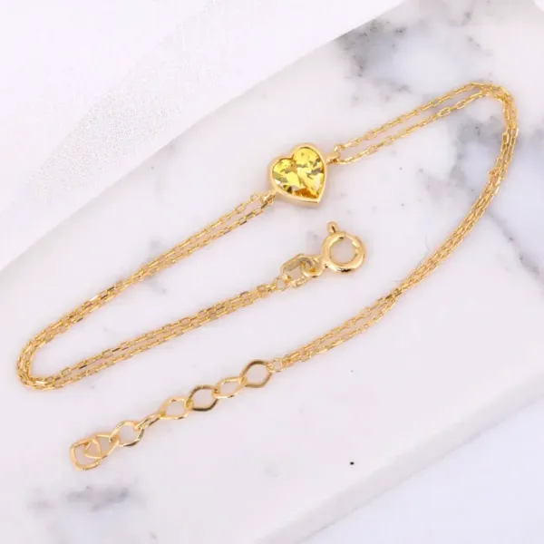 Yellow Topaz Heart Bracelet on white stone background